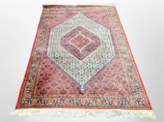 A machine made rug of Tabriz design,