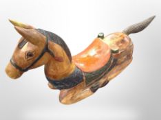 A carved and painted wooden rocking horse,