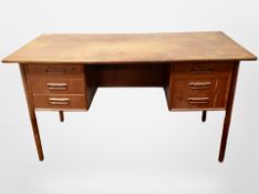 A 1970's Danish teak writing desk fitted six drawers,