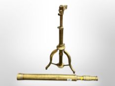 A brass telescope on tripod stand CONDITION REPORT: Has several dents