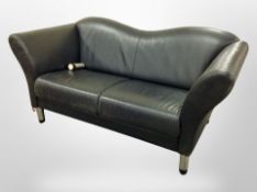 A contemporary black stitched leather two seater settee on metal legs,
