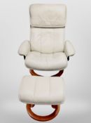 A cream leather swivel relaxer chair with matching footstool