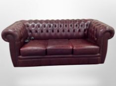 A Chesterfield oxblood leather three seater settee,