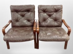A pair of Danish stained beech and brown buttoned leather armchairs,