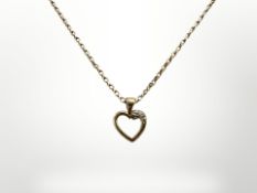 A 9ct yellow gold necklace with heart shaped pendant set with a diamond, length 46 cm.