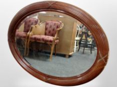 An oval mahogany framed mirror,