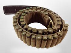 A leather and canvas bandolier by The El Paso Saddlery Company containing approximately fifty inert