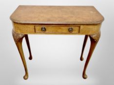 A burr walnut D-shaped side table, on cabriole legs,