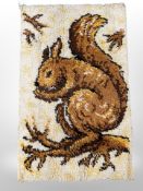 A 1970's wool rug depicting a squirrel,