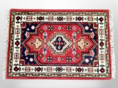 A small Iranian fringed rug 95 cm x 62 cm
