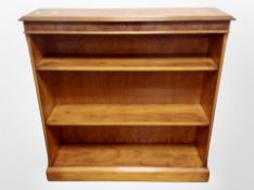 A yew wood open bookcase,