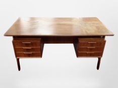 A 1970's Danish teak writing desk fitted three drawers each front pedestal,