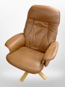 A tan leather swivel armchair