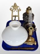 A cast metal oil lamp base, opaque glass shade, brass easel, pestle and mortar,