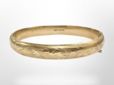 A 9ct yellow gold bangle, diameter internally approximately 60 mm.