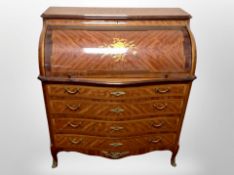 A reproduction king wood veneered and satinwood inlaid serpentine front bureau on paw feet,