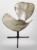 A metal barrel swivel chair