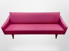 A 20th century Scandinavia four seater settee in pink upholstery,