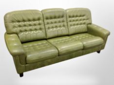 A 1970's Danish green button leather three seater settee,