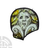 Medieval Ovoid Stained Glass Panel Depicting a Grotesque Mask