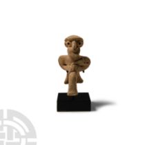 Western Asiatic Terracotta Seated Male Figure Holding an Axe