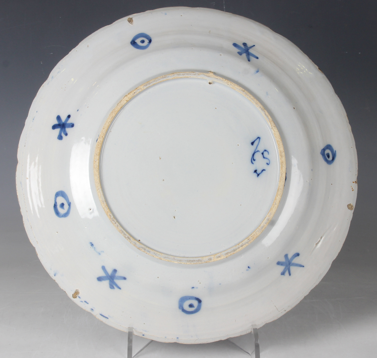 A Dutch Delft dish, probably De Porceleyne Claeuw, first half 18th century, painted in blue with a - Image 6 of 8