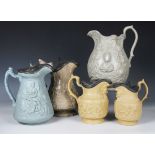 Fifteen assorted relief moulded stoneware jugs, 19th century, in varying colours, some with pewter
