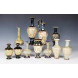 A collection of Doulton Slaters Patent stoneware vases and a jug, all decorated with floral motifs