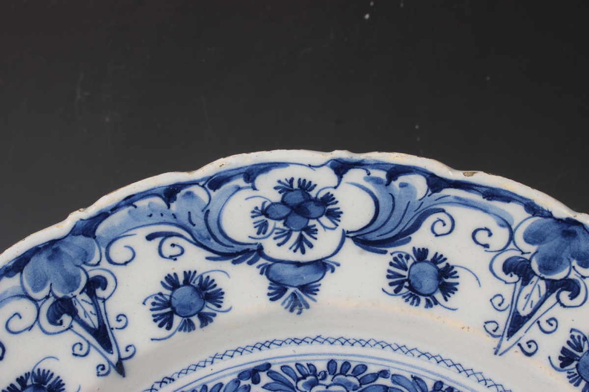 A Dutch Delft dish, probably De Porceleyne Claeuw, first half 18th century, painted in blue with a - Image 7 of 8