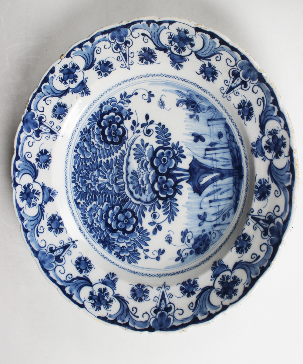 A Dutch Delft dish, probably De Porceleyne Claeuw, first half 18th century, painted in blue with a - Image 4 of 8