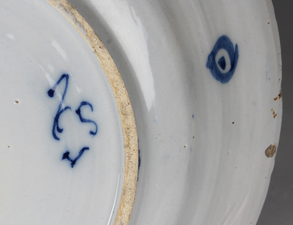 A Dutch Delft dish, probably De Porceleyne Claeuw, first half 18th century, painted in blue with a - Image 5 of 8
