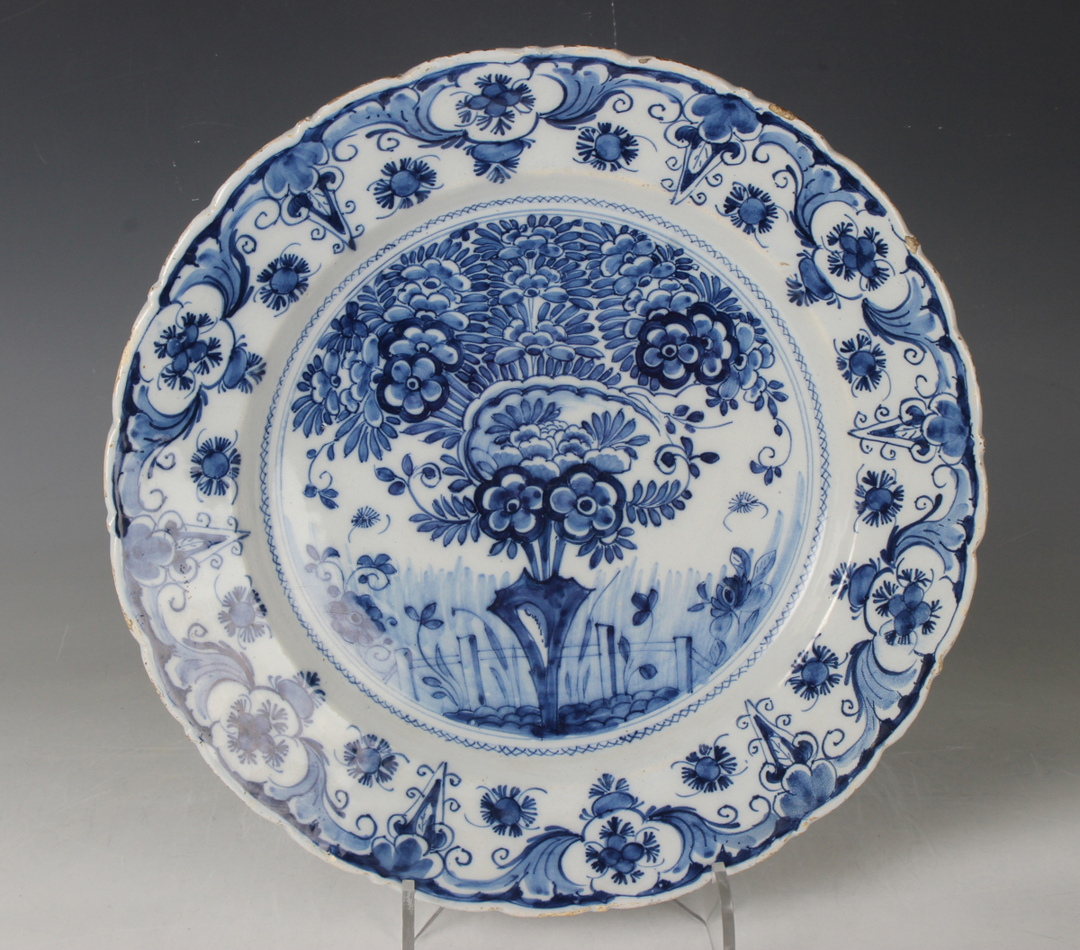 A Dutch Delft dish, probably De Porceleyne Claeuw, first half 18th century, painted in blue with a