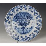 A Dutch Delft dish, probably De Porceleyne Claeuw, first half 18th century, painted in blue with a