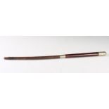 An early to mid-20th century military riding crop with nickel finial, embossed with details and