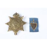 A George V Duke of Cornwall's Light Infantry helmet badge and a Second World War period 73rd