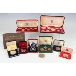 A collection of Royal Mint silver proof coins, including a Britannia four-coin set 1997 and a