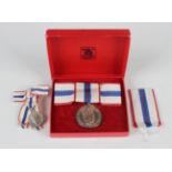 An Elizabeth II Silver Jubilee Medal 1977, lady's issue, with bow ribbon, with the original Royal