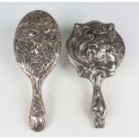 An Art Nouveau plated hand mirror, relief decorated with a maiden with flowing hair and flowers,