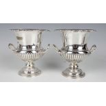 A pair of late Victorian silver campana urns, each with scalloped and gadrooned rim above a pair