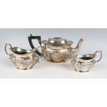 An Edwardian silver harlequin bachelor's three-piece tea set of lobed oval form with embossed