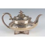 A George IV silver teapot of squat oval half reeded form, the hinged lid with acorn and oak leaf