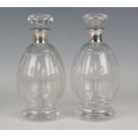 A pair of George VI silver mounted Stourbridge cut glass decanters and stoppers, each with a