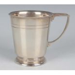 A George VI silver christening tankard of tapering cylindrical form, on a circular foot cast with