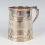 A George IV silver christening tankard of tapered cylindrical reeded form with scroll handle, London
