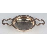 A George II silver lemon strainer, the pierced circular bowl engraved with a squirrel crest, flanked