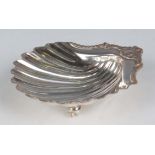 A George III silver scallop shell butter dish with gadrooned and scroll rim, raised on shell feet,