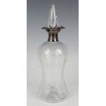 A George V silver mounted cut glass decanter and stopper, fitted with a twin-lipped pouring collar