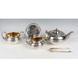 A George III harlequin silver four-piece tea set of squat circular girdled form, crest engraved,