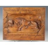 An early 20th century Continental walnut plaque, carved in deep relief with the Lion of Lucerne