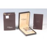 A Dupont Paris silver plated 'Gatsby' lighter with diamond point pattern to the rectangular body,